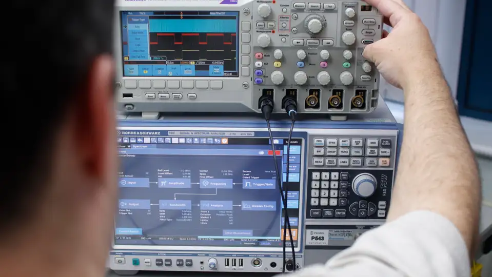 an engineer using some equipment for signal processing and testing