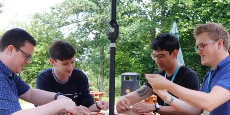 some of our engineers enjoying pizza at one of our weekly lunch events